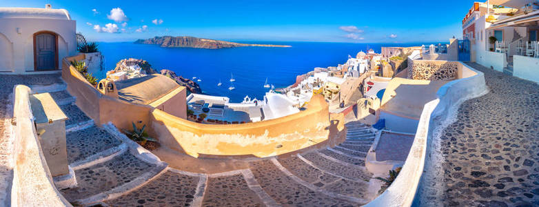 希腊圣托里尼岛伊亚镇。传统和著名的房子和教堂与蓝色圆顶上的口，爱琴海