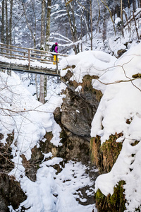年轻女子徒步穿越雪山峡谷 Baerenschuetzklamm 冰冻瀑布