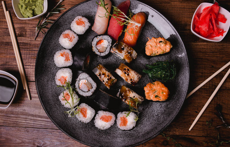寿司集握和卷在棕色木桌背景上服务。热门美食摄影