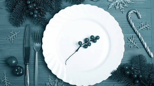 圣诞节餐桌上的盘子和盘子。节日餐桌设置