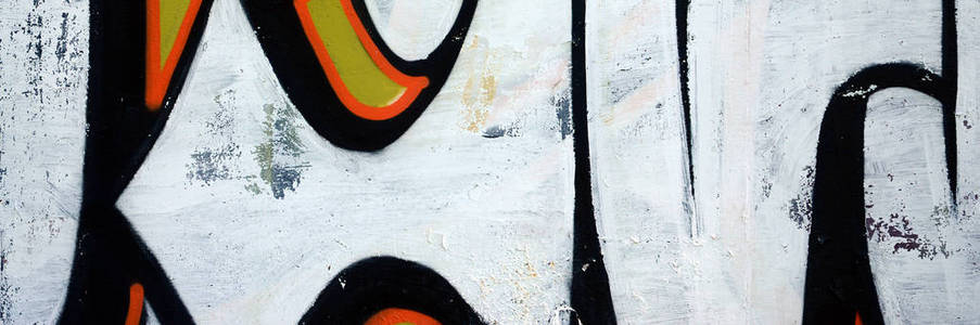 街头艺术。白色和橙色色调的彩色涂鸦画片断的抽象背景图像
