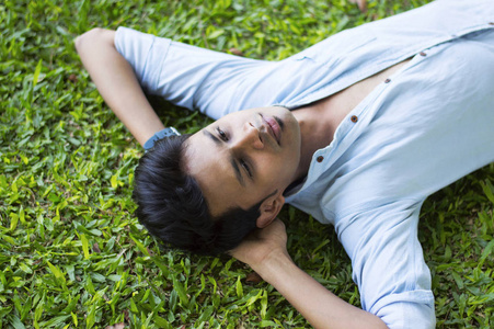 快乐和年轻人躺在草地上放松