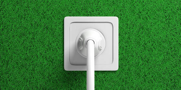 绿色能源概念。电源插头和插座隔离在绿草背景上。3d 插图