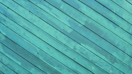 旧漆的木墙。纹理。老式木材背景与剥离油漆。彩绘纯蓝绿色仿古木板背地