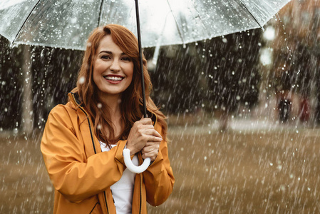 雨中站在外面的快乐女孩