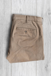 白色木质背景折叠棕色长裤