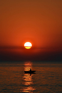 渔夫在小船鱼在日落