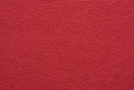 空白和干净的背景或墙纸与抽象针织纹理的织物或纺织材料的特写红颜色