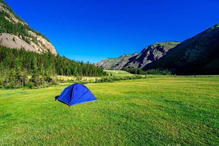 在山间的草地上的帐篷。在山脚下露营