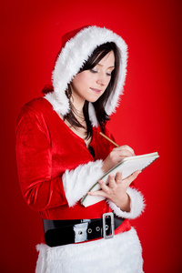 圣诞女人特别礼物记笔记做在红色背景