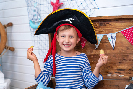以海盗的形式在掌舵的男孩。节日装饰海盗风格