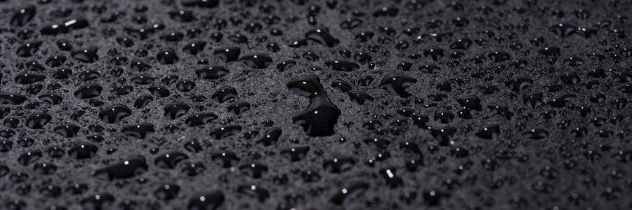 水在黑色的背景下落下。黑色抽象背景