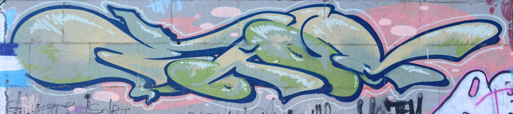 涂鸦画碎片。在街头艺术文化的风格上装饰着漆渍的旧墙。绿色色调的彩色背景纹理