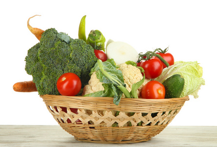 新鲜蔬菜在白色背景上的木桌上的篮子里