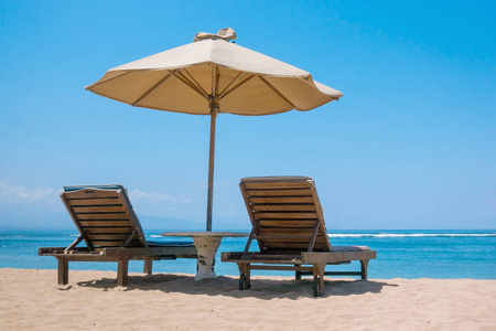 两个在海滩上休闲座椅与太阳伞