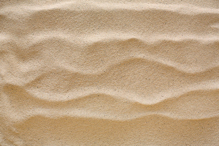 沙滩沙背景。天然海滨纹理表面