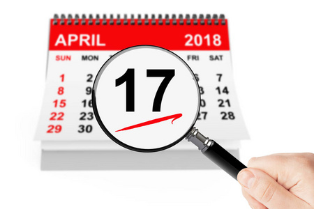 纳税日概念。2018年4月17日日历与放大镜