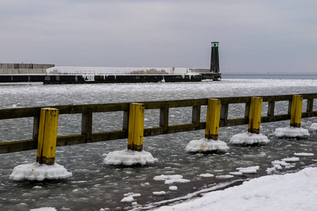 灯塔在港口码头。港口被冰覆盖