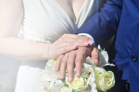 新婚夫妇捧着一束美丽的结婚花束。古典婚礼摄影, 象征着团结, 爱和创造一个新的家庭