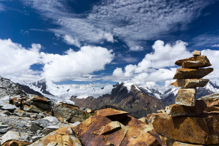 山上的景观在安第斯山脉与一个红色的岩石, 在前景下一个表现狡猾的石冢