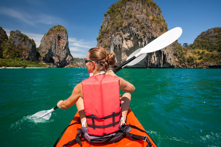 泰国甲米海岸, 妇女在开阔的海面上划独木舟。