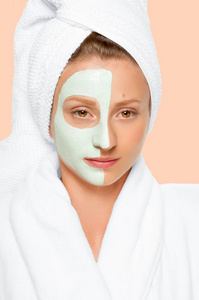 美容水疗中心。女人脸上涂上了粘土面具。柔和背景