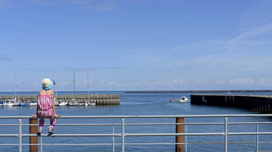 小女孩坐在栏杆上, Helgoland 港