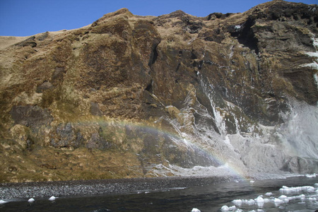 Skogafoss 瀑布在冰岛。冰岛南部冰岛自然景观的著名旅游胜地和地标目的地。冬季瀑布上的彩虹