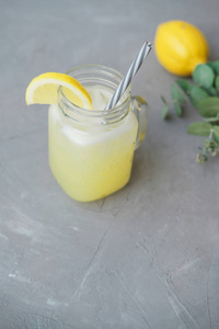 灰色背景玻璃罐中的柠檬水