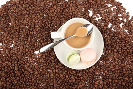 蛋白杏仁饼干与豆在白色背景上的咖啡杯