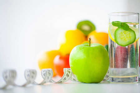 饮食。健康饮食理念。平衡的饮食与水果。新鲜的绿色水果, 在白色的背景上测量磁带。特写
