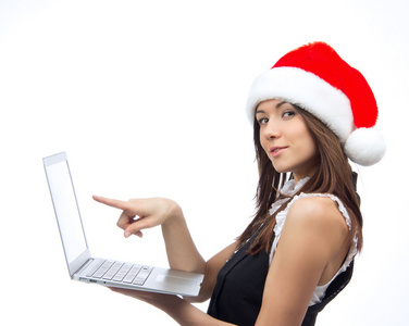 圣诞女人指着显示器的笔记本电脑
