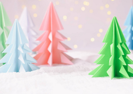 折纸3d 圣诞树从纸上白色背景和散景灯。圣诞快乐, 新年贺卡。纸艺风格。复制空间。选择性聚焦