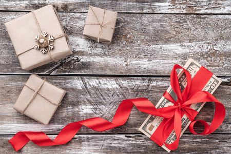圣诞节背景的老木头, 钱点缀着红色的松弛和礼物。顶部视图