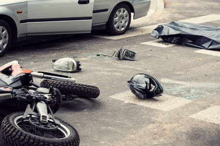 黑色头盔和摩托车的道路后, 致命的碰撞与汽车