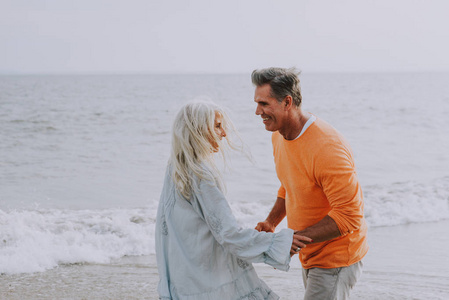 幸福的老夫妇在海滩上度过。关于爱情资历和人的概念