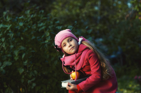 一个女孩的肖像在秋天的公园, 一个孩子穿着红色温暖的外套