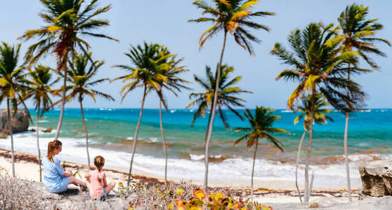 享受热带海滩的母亲和女儿在加勒比海假期在巴巴多斯