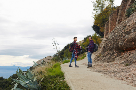 ouple hiking on a mountain trail together