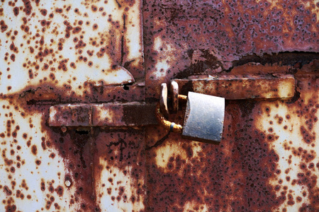 老生锈的锁在白色和棕色生锈的门。生锈的老锁在红色背景, 地方为文本