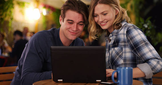 快乐的男人和女人在笔记本电脑上看视频笑着笑着