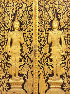 泰国文化黄金雕塑在寺庙的墙上图片