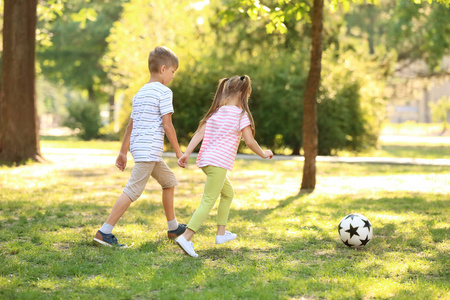 可爱的小孩在户外踢足球