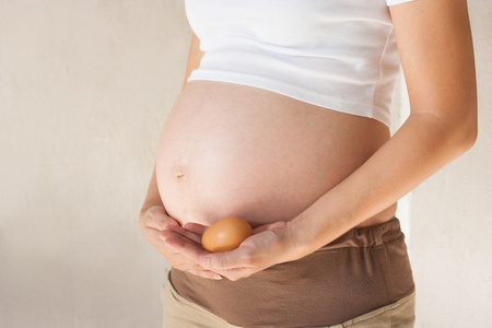 孕妇的肚子和手里的蛋