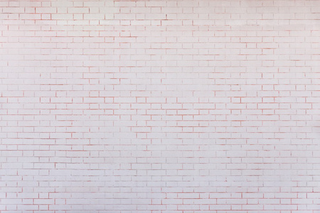 淡粉红色纹理的表面的一堵墙