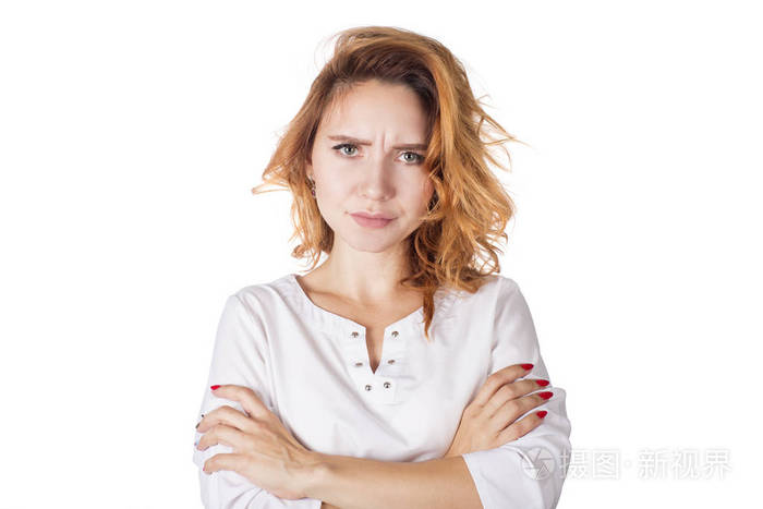 自信的女人用愤怒的目光注视着镜头, 双臂抱在臀部.