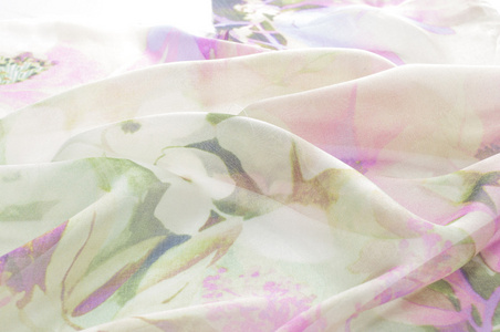 织物丝淡粉色与白色的花。织物的背景