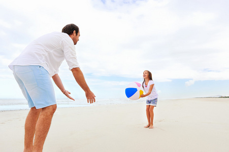 父亲和女儿在海滩上玩