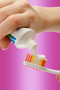 牙刷和牙膏在女性手中