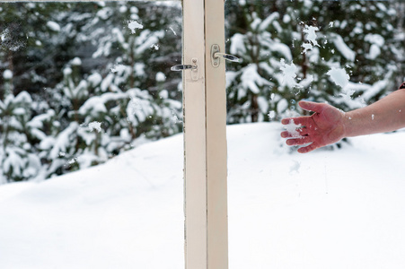 手在木制窗户扔雪